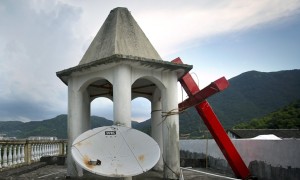 A cut-down cross on a church roof in Zhejiang province. Photograph: Mark Schiefelbein/AP