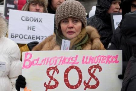 20150112-russia_a-protester-holds-a-banner-reading.jpg